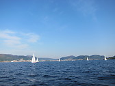 Bergen city centre at distance, as viewed from a boat in Byfjorden fjord. May 2012