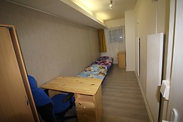 Furnished bedroom with window to street in the ground floor