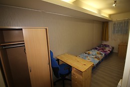 Furnished bedroom with window to street in the ground floor