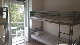 Bed in a room with 2 windows