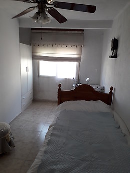 Habitación luminosa con cama rústica individual