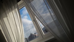 Quaint room with stunning views in sunny apartment.