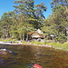 Kayaks on a lake and a Man in a Tent