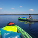 Kayaks on a lake and a Man in a Tent