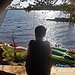 Kayaks on a lake and a Man in a Tent